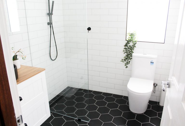 black-tiles-bathroom-flooring-remodel-glass-door-shower