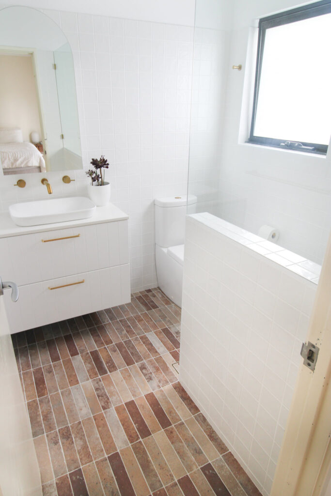 after-bathroom-renovation-gold-fixtures-single-floating-vanity