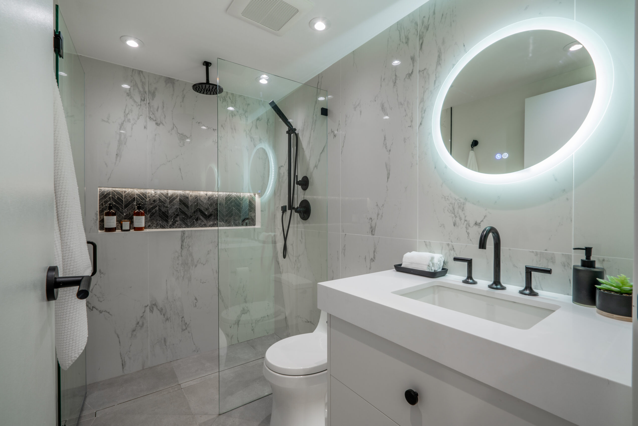 bathroom-renovation-vancouver-downtown-white-tiles-niche-vanity-black-fixtures