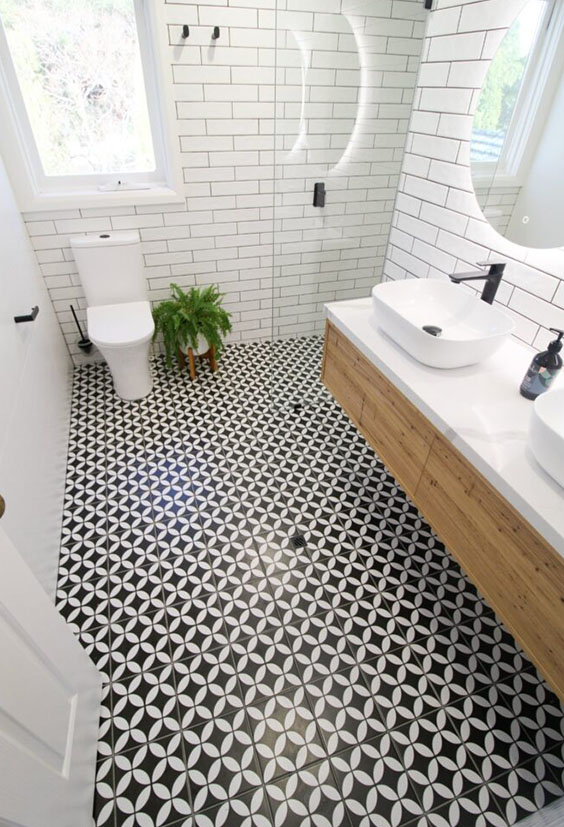 after-bathroom-renovation-black-and-white-tiles-double-vanity-rounded-mirror